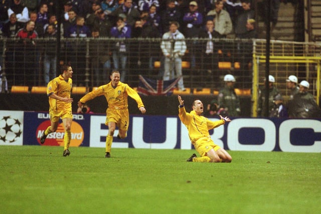 Mark Viduka celebrates scoring to help his team through to the quarter-finals of the Champions League as Leeds demolished the Belgium champions in Brussels.