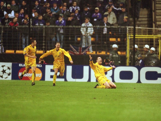 Mark Viduka celebrates scoring to help his team through to the quarter-finals of the Champions League as Leeds demolished the Belgium champions in Brussels.