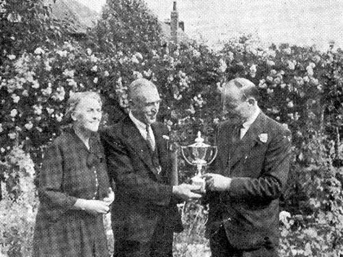 Mr. & Mrs. J. Sheldon receive the Charles Tetley Cup awarded for the best non-Corporation Garden in the 1951 competition. The winning garden was located at number 183 Stanningley Road.