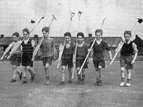 A row of young pupils of Belle Isle County Primary as they shoulder their hoes in readiness for the Flowers For Leeds competition in 1951.
