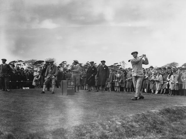 Fred Robson tees off on the 18th. Standing, centre, is Gene Sarazen of the USA.