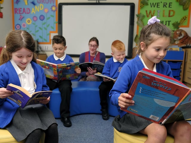 Reading in the school library with Librarian Mrs Newill.