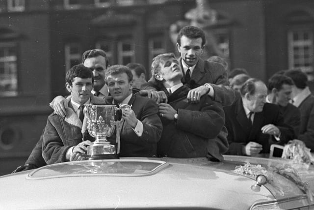 The players with the trophy during the homecoming parade.