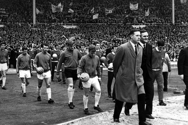 The players walk about at Wembley in March 1968.