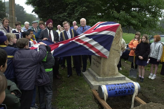 The Lord Mayor of Leeds, Coun Bernard Atha, and local children unveil the Millennium Stone on Armley Moor.