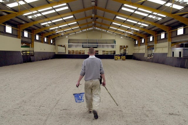 A workman walks down the centre of the new indoor riding arena at the Middleton Park Riding for the Disabled which was nearing completion.