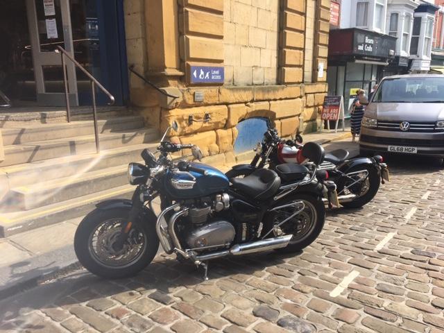 Chefs' motorcycles parked outside.