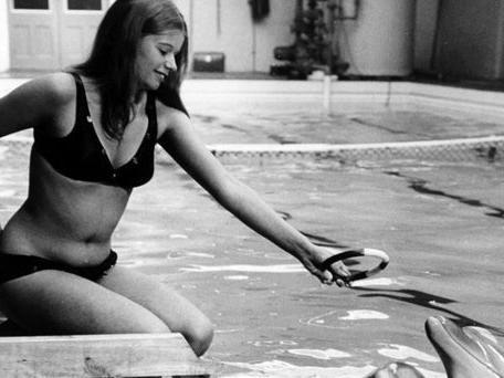 An old favourite- Susan Pickering, 20, training dolphins at the old swimming pool in South Elmsall, pictured between 1972 and 1974