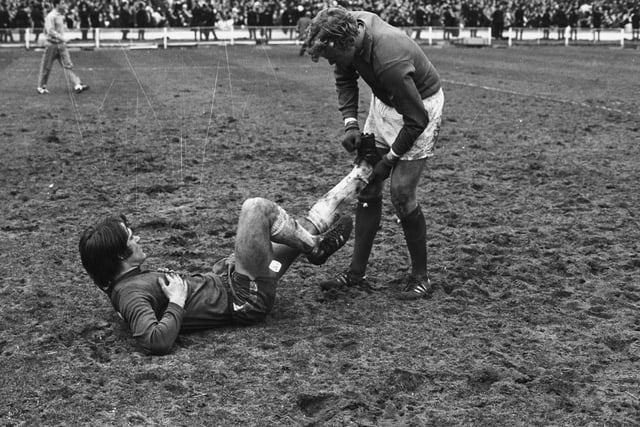 Gary Sprake tends to rival Chelsea player Dave Webb after he goes down with cramp during the FA Cup final at Wembley in April 1970.