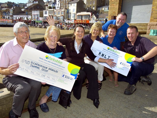 Daniella Jordan (centre) from Yorkshire Building Society, handing out
special annual charity donations, as chosen by customers.