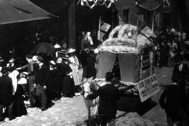 A horse-drawn decorated float by Oliver Hudson and Son of Pudsey, manufacturers of wholesale and retail confectionery, is seen in the centre. Year unknown.