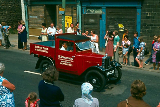 A vehicle belonging to R. Tomlinson forming part of a parade of floats travelling along Upper Town Street during the Bramley Carnival in July 1976.
