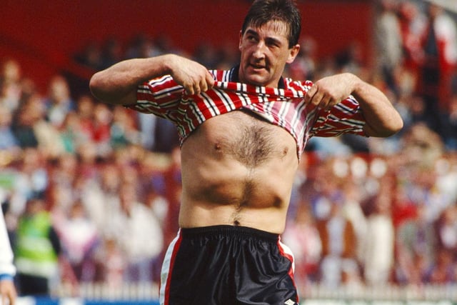 Sheffield United striker Billy Whitehurst lifts his shirt to supporters.