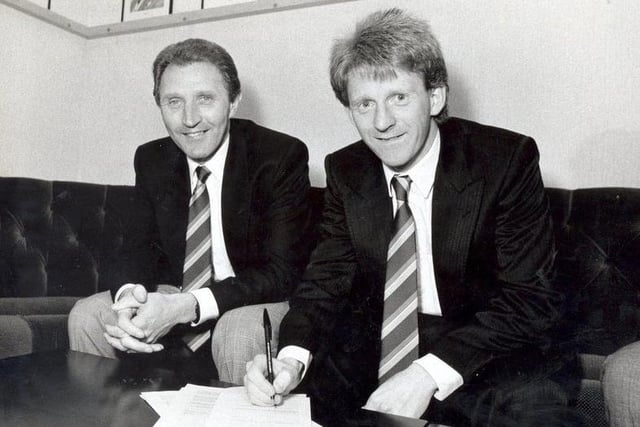 Gordon Strachan signs on the dotted line for Leeds United manager Howard Wilkinson in 1989.