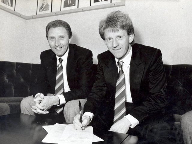 Gordon Strachan signs on the dotted line for Leeds United manager Howard Wilkinson in 1989.