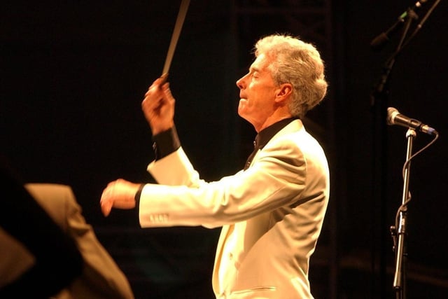 John Pryce-Jones conducts the orchestra at the Classical Fantasia 2003 concert at Kirkstall Abbey.