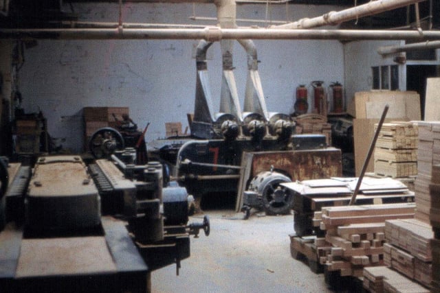 Inside James Lupton and Sons Ltd, cabinet makers at Tong Road Mills in 1959. This is the main machine room with a drum sander in the background.