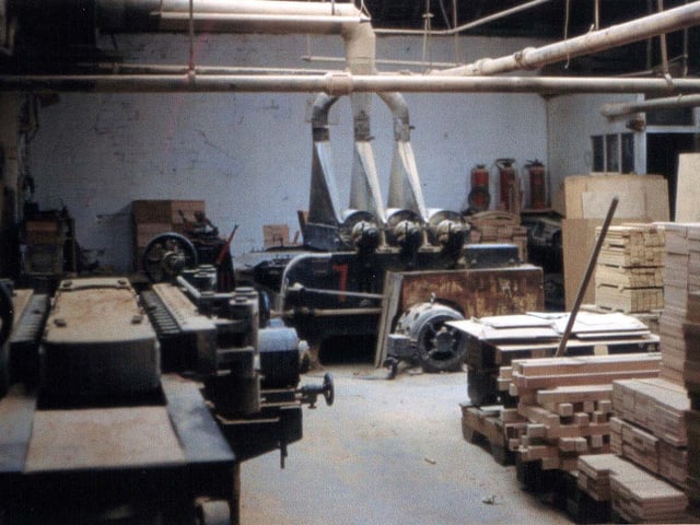Inside James Lupton and Sons Ltd, cabinet makers at Tong Road Mills in 1959. This is the main machine room with a drum sander in the background.