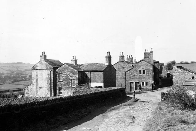 Looking along Heights Lane in March 1950. Outbuildings and a streetlamp are also visible. This is Lower Heights looking down to Pudsey Road.