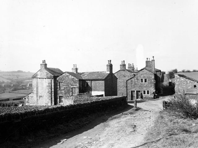 Looking along Heights Lane in March 1950. Outbuildings and a streetlamp are also visible. This is Lower Heights looking down to Pudsey Road.