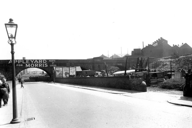 May 1956. Viaduct Road in Armley which passes under the L.N.E.R railway track. The premises of 'Appleyard for Morris, on North Street', is advertised across the bridge. To the right is 'Appleyards Scrapyard'