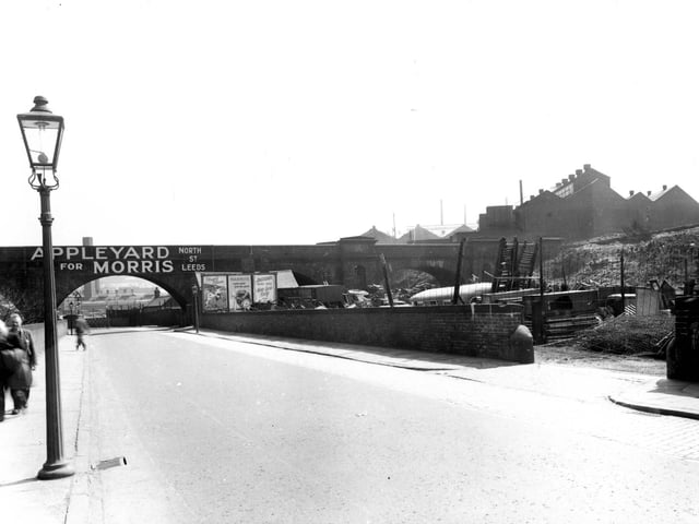 May 1956. Viaduct Road in Armley which passes under the L.N.E.R railway track. The premises of 'Appleyard for Morris, on North Street', is advertised across the bridge. To the right is 'Appleyards Scrapyard'