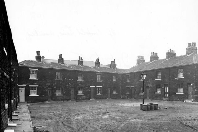 January 1956. Ellis Square on Theaker Lane. Square of houses, with streetlamp surrounded by dustbins in the middle.
