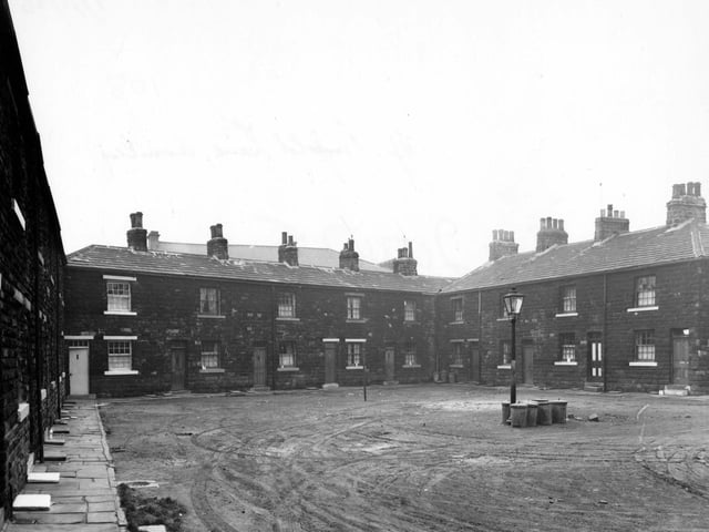 January 1956. Ellis Square on Theaker Lane. Square of houses, with streetlamp surrounded by dustbins in the middle.