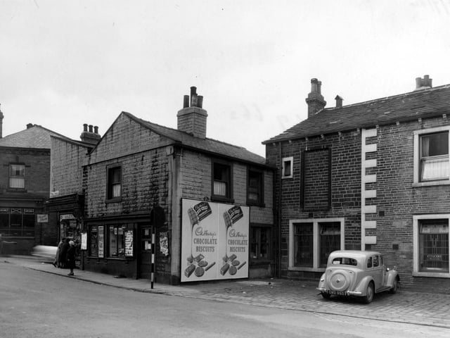 Town Street in July 1954 looking at the premises of Gibbs and Son, newsagent. Next door is the Concert Rooms.Lloyds Bank Ltd. can be seen in the far left of the photograph.