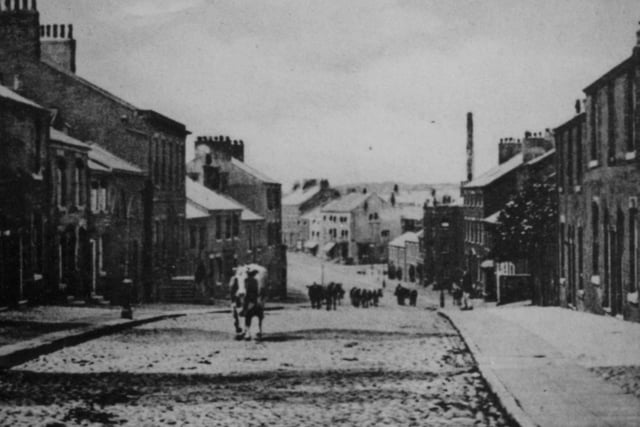 This scene of cattle being herded up Preston Street, Kirkham in 1905 would be a very rare sight today, but  many of the buildings remain