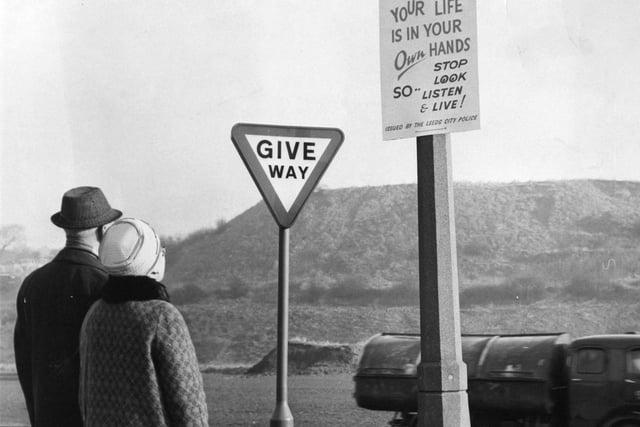 Residents of the 'Mad Mile' area of Farnley read a new warning notice put up by Leeds City Police at the junction of Whincover Drive and Farnley Ring Road in February 1970.