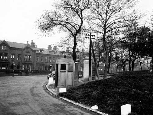 Leeds City Police box, two telephone boxes and telegraph pole on grassed area with trees at south west corner of Woodhouse Moor in October 1946.