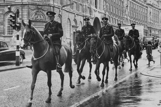 Members of Leeds City Police mounted division riding along The Headrow on June 1967.
