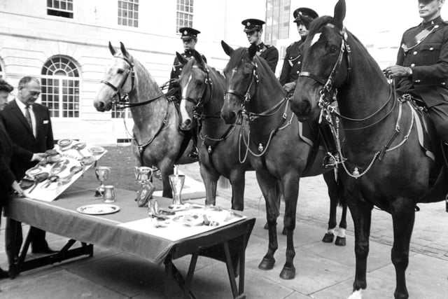 October 1973 and chairman of the Leeds Watch Committee, Coun James Atha (left), and James Angus, Chief Constable of Leeds, admire some of the trophies won by Leeds City Police Mounted Section during the year.