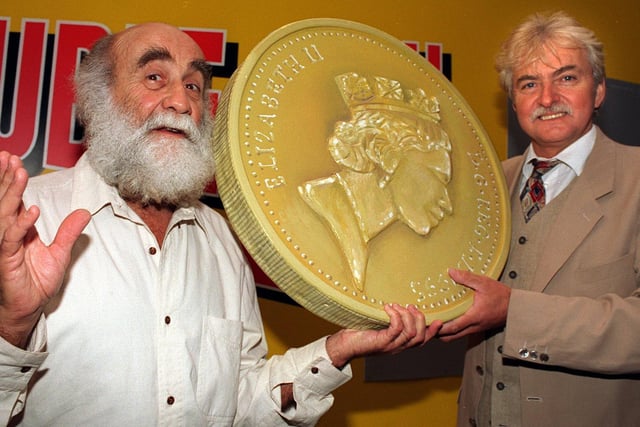 Actors Warren Mitchell (left) and Tony Scannell used a giant £1 coin and card to launch the new Littlewoods scratchcards at the Victoria Quarter.