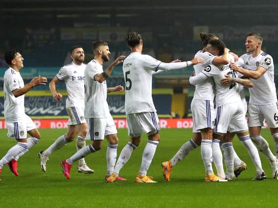 Leeds United's players head to celebrate with Rodrigo after his strike put the Whites level against Manchester City. Photo by Catherine Ivill/Getty Images.