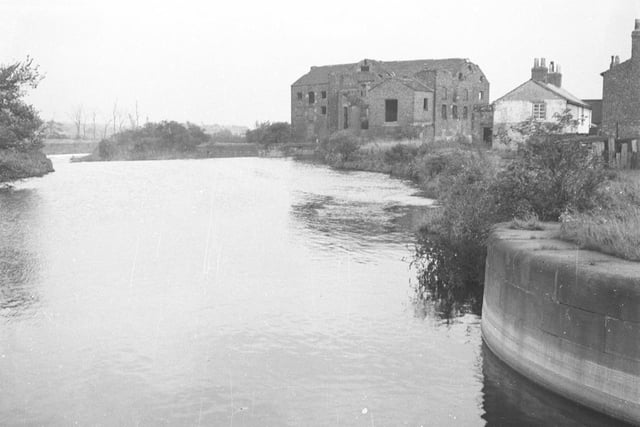 An undated photo of the derelict shell of Fleet Mill on Fleet Lane along with houses forming part of the village of Fleet, now dissappeared. An oil terminal has occupied the site since the late 1950s.