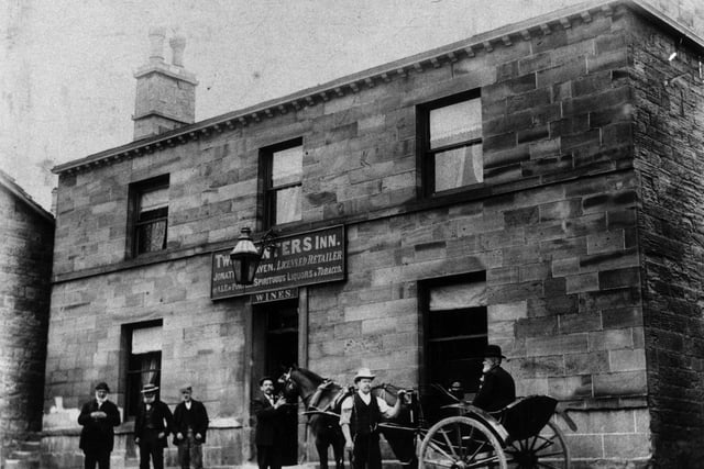 The Two Pointers Inn at the north end of Church Street, with a small groups of men standing outside. One is seated in a pony and trap. The Inn is still in existence, with alterations having been made to the front.