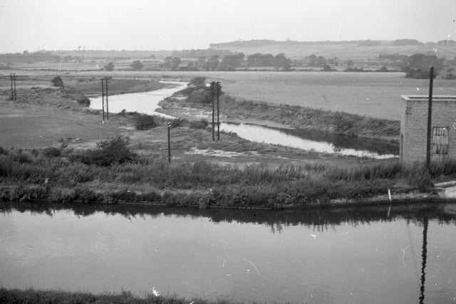An undated view of the Aire & Calder Navigation and River Aire looking from Woodlesford Lock.In the distance, on the right, is Waterloo Main colliery, and the wooded ridge seen behind it is part of the Temple Newsam estate.