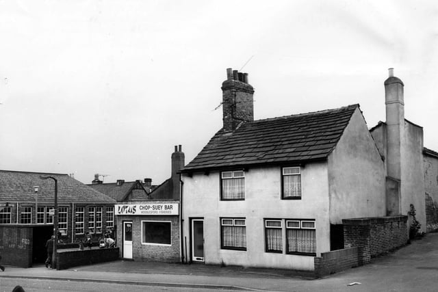 April 1980 and pictured is Lotus Chop Suey Bar and Woodlesford Fisheries, with a house alongside. On the left is a bus shelter; behind this is Highfield Lane and Woodlesford Junior and Infant School.