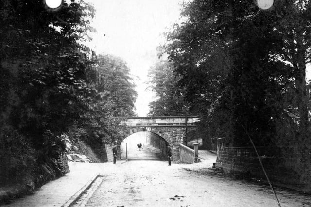 Aberford Road looking north-east along a tree-lined road towards the railway bridge. The junction with Station Lane can be seen. Year unknown.