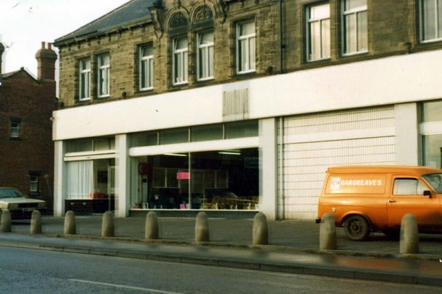 A view of Aberford Road in October 1979 showing the frontage of Leeds Upholstery Service adjacent to the Midland Bank.
