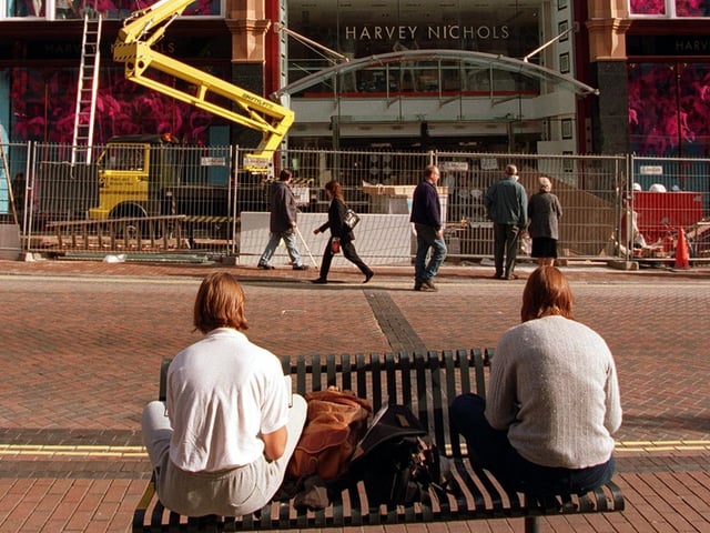 Two art students try to capture on paper the final preparations being carried out on the new Harvey Nichols department store in October 1996.