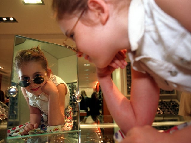 Seven-year-old Emma Horton enjoys the sun glasses section on the opening day.
