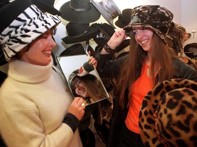 Mum Anne Richmond with daughter also Anne try out the hats stall.
