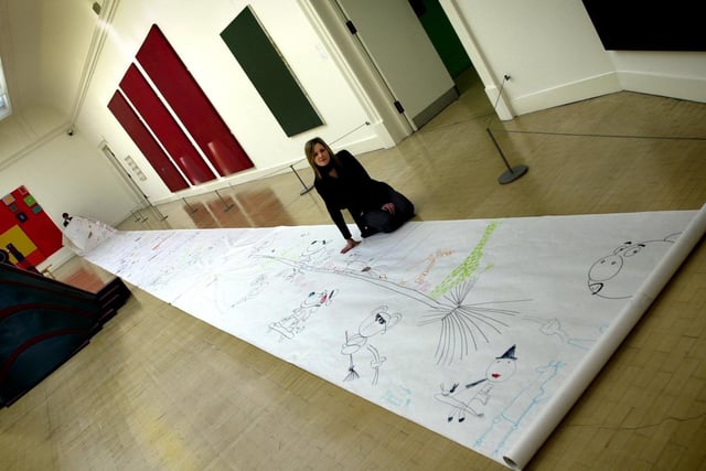 Assistant curator Lisa Fieldhouse with the 42 metre long cartoon which went on display Leeds City Art Gallery.