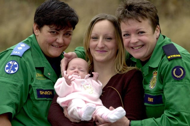 Debbie Vickers (centre) with her baby girl Asha was delivered at her home in Leeds by Keren Dunn (right) a West Yorkshire Ambulance Service trainee paramedic on her first day.