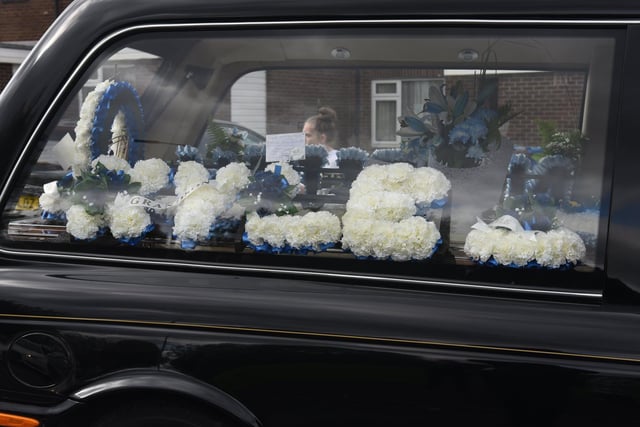 Flowers spell out Kyle's name in the hearse