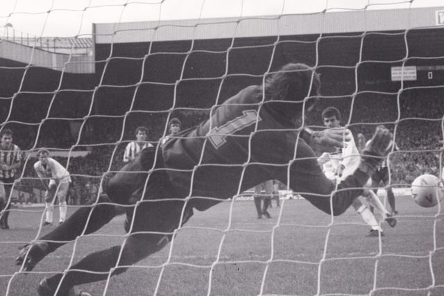 Peter Lorimer equalises from the penalty spot against Sheffield United at Elland Road in October 1984 despite the best efforts of Blades goalkeeper Keith Waugh.