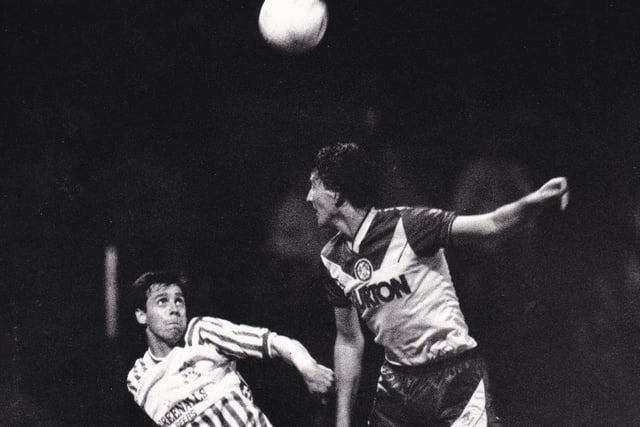 John Pearson wins an aerial duel in the goalless draw against Huddersfield Town at Leeds Road in September 1987.